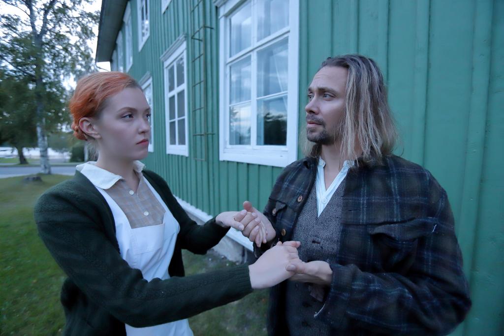 Näyttelijät Jaana Ilkko ja Jarno Markus-Hannelin. Kuva: Raahen teatteri. Vanhanaikaisiin vaatteisiin pukeutunut pariskunta.