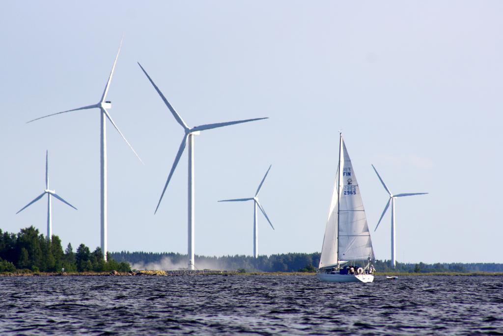 Wind turbines and a sailing boat.
