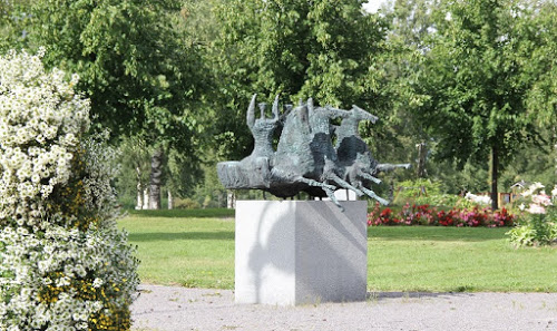 Juvan veistospuistossa kukat kehystävät veistoksia. Kuva Tita Haapajoki. Patsas Juvan veistospuistossa. Kuva Tita Haapajoki.