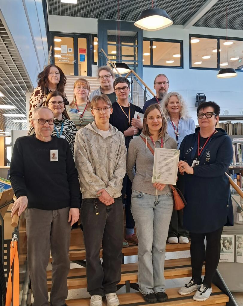 Kuvassa osa pääkirjaston henkilökunnasta seisomassa portaikossa.