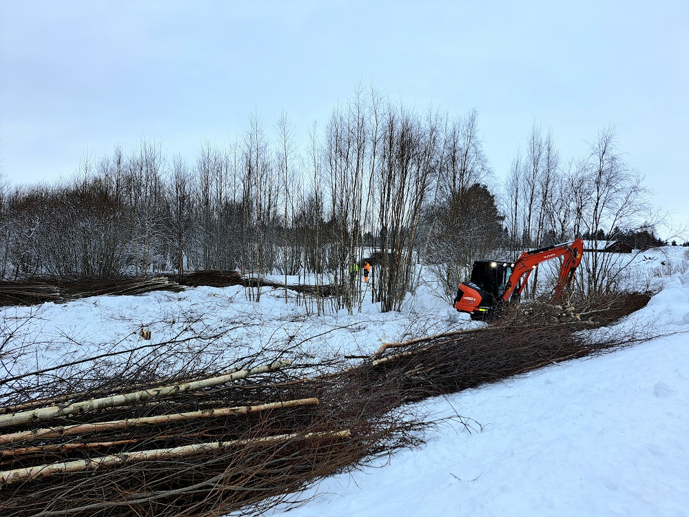 Kaivuri risusavotassa. Kaivuri Mettalanväylällä.