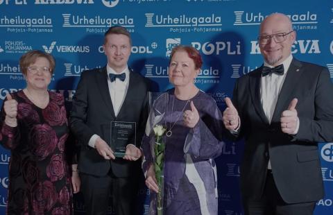 Kuvassa palkinnon vastaanottajat pokaalin kanssa.