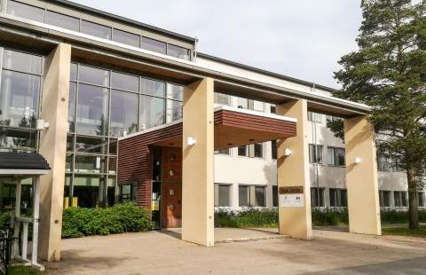 A tall building with a glass wall.