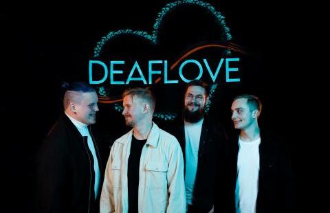 Deafloven neljä jäsentä seisoo turkoosin Deaflove logon edessä.