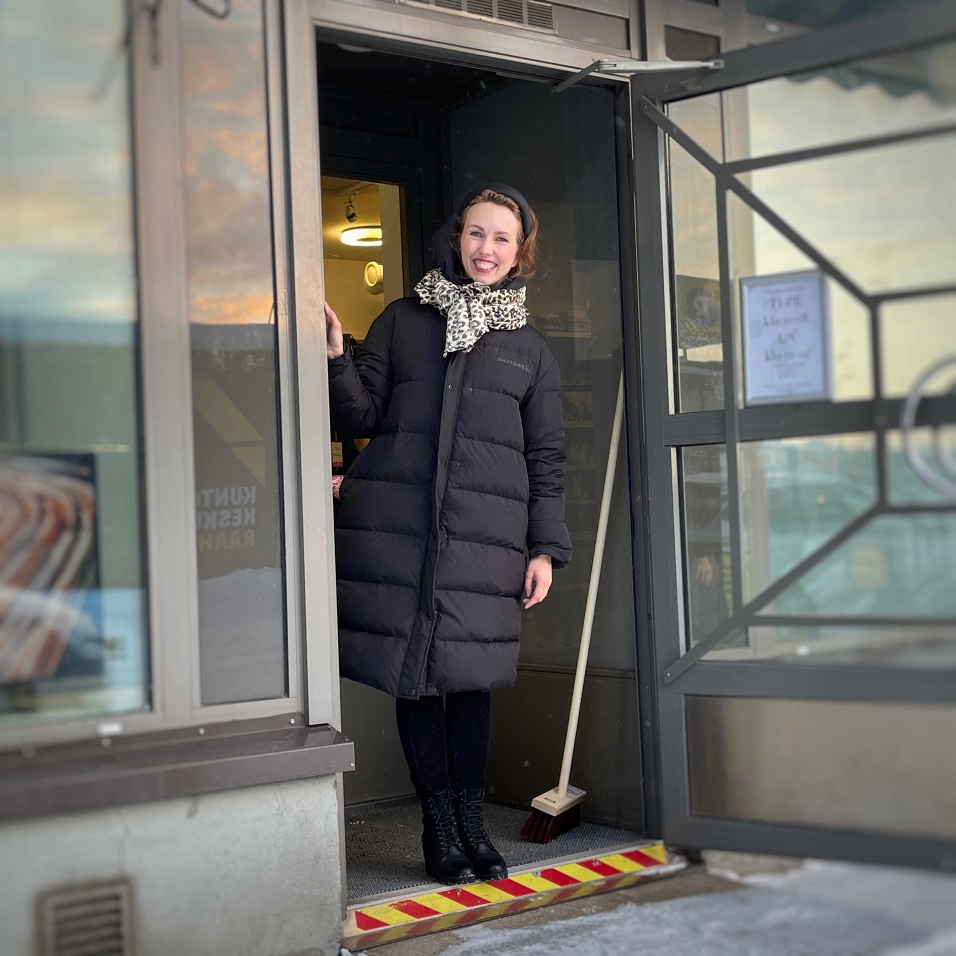 The ever-smiling Heidi at the door of her shop.