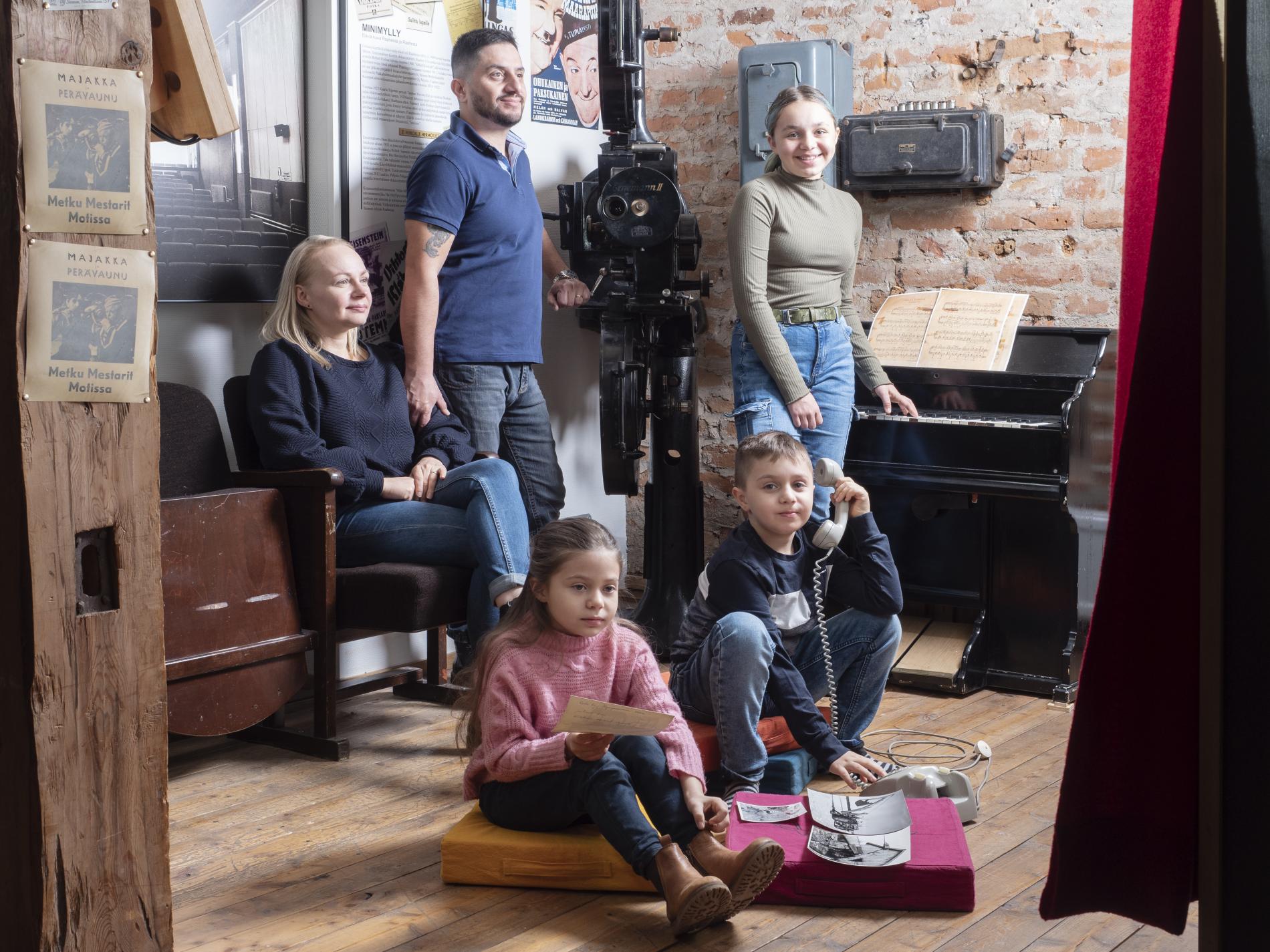 A woman and a man with three children at the Crown Granary Museum.